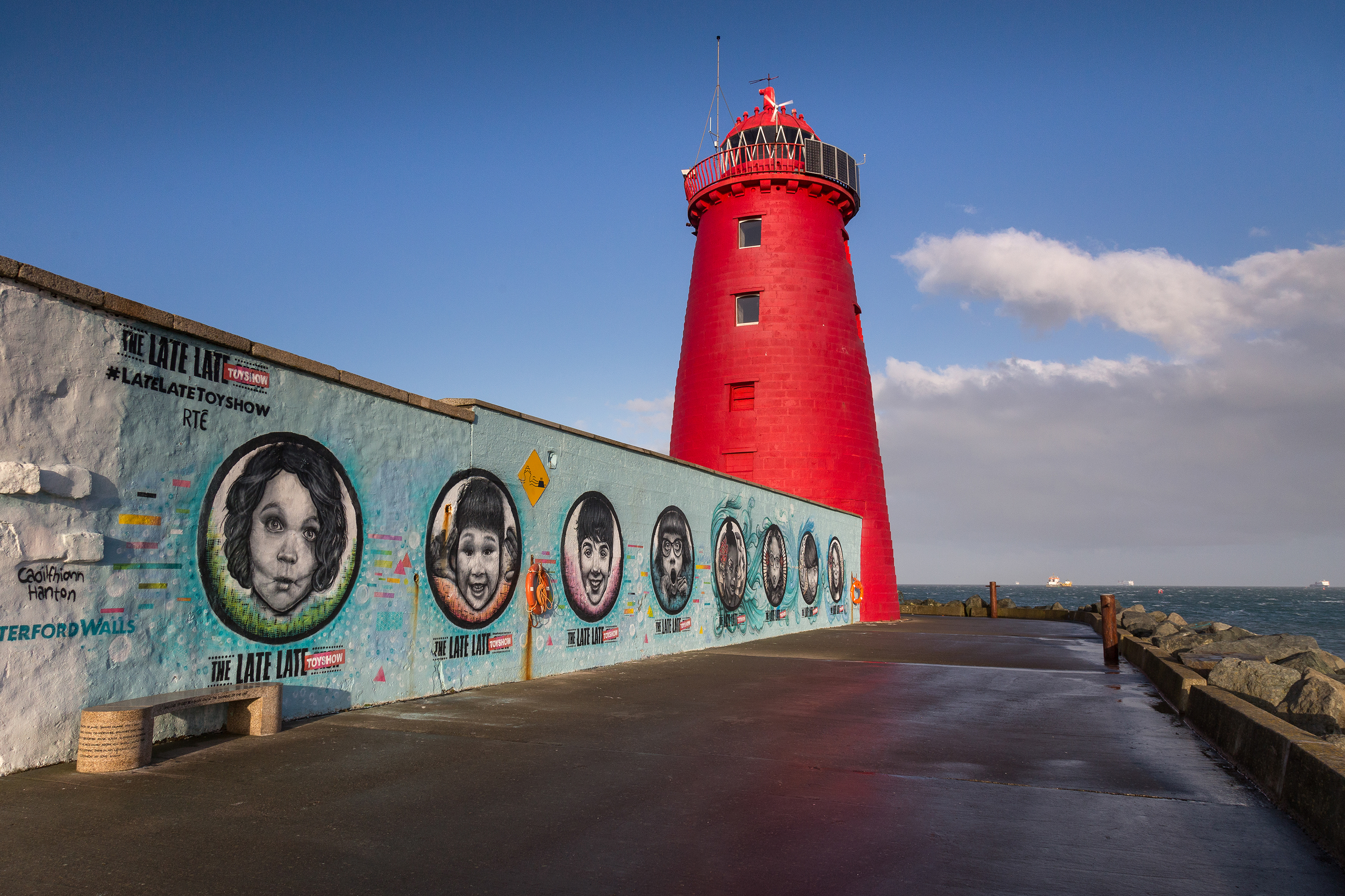Image of wall with mural and red lighthouse